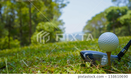 Golf clubs and golf balls on a green lawn in a beautiful golf course with morning sunshine. Golf clubs and golf balls on a green lawn in a beautiful golf course with morning sunshine. 138610690