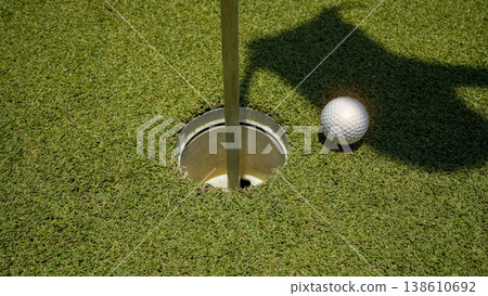 Golf ball is on a green lawn in a beautiful golf course with morning sunshine. Golf ball is on a green lawn in a beautiful golf course with morning sunshine. 138610692