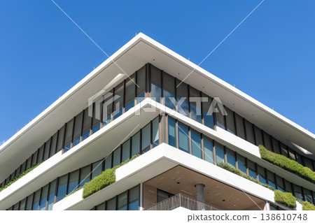 Residential building architecture. Architectural exterior detail. Residential house exterior fragment. Modern apartment building. Apartment building with balcony. View of building Residential building architecture. Architectural exterior detail. Residential house exterior fragment. Modern apartment building. Apartment building with balcony. View of building 138610748