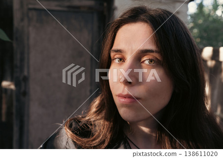 Young woman portrait in warm golden hour sunlight outdoors Young woman portrait in warm golden hour sunlight outdoors 138611020