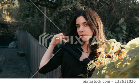 Young woman portrait in garden with warm natural sunlight 138611026