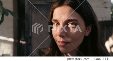 Smiling young woman portrait in warm natural outdoor light 138611110
