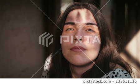 Young woman looking upward in warm natural light 138611136