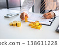 Gold Trading Businessman invest in trading gold, calculating profit price of buy and sell gold. 138611228