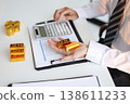 Gold Trading Businessman invest in trading gold, calculating profit price of buy and sell gold. 138611233