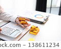 Gold Trading Businessman invest in trading gold, calculating profit price of buy and sell gold. 138611234