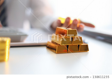 Gold Trading Businessman invest in trading gold, calculating profit price of buy and sell gold. 138611235