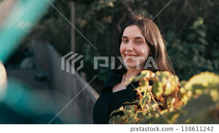 Smiling young woman portrait outdoors in warm natural light 138611242