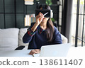 Women wear goggle headsets at work for virtual collaboration, designing 3D models, immersive training, and analyzing data in a virtual space. 138611407