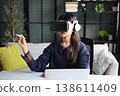Women wear goggle headsets at work for virtual collaboration, designing 3D models, immersive training, and analyzing data in a virtual space. 138611409