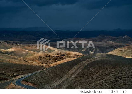 Desert canyon landscape with rocky cliffs and rugged mountain terrain 138611501