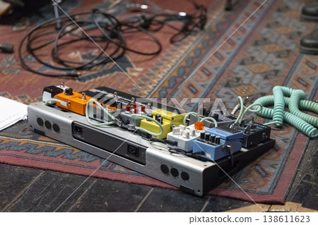 Guitar effect pedals arranged on a pedalboard for music production 138611623