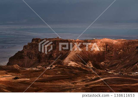 Dramatic desert coastline landscape with storm clouds over calm sea 138611653