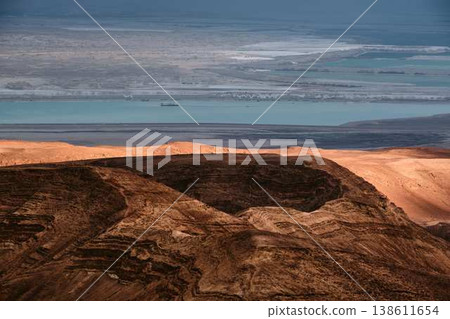 Dramatic desert coastline landscape with storm clouds over calm sea 138611654