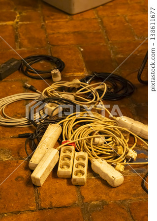 Tangled power strips and electrical cables on floor Tangled power strips and electrical cables on floor 138611677