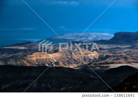 Dramatic desert coastline landscape with storm clouds over calm sea Dramatic desert coastline landscape with storm clouds over calm sea 138611691