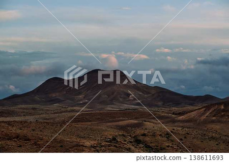 Dramatic desert coastline landscape with storm clouds over calm sea 138611693