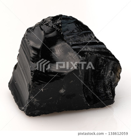 Polished Black Obsidian Volcanic Glass Rock with Sharp Conchoidal Fractures and Glossy Reflective Surface Texture. 138612059