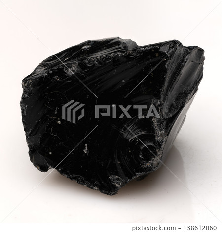 Polished Black Obsidian Volcanic Glass Fragment with Sharp Conchoidal Fractures and Glossy Reflective Surface Texture. 138612060