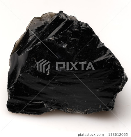 Polished Black Obsidian Volcanic Glass Rock with Sharp Conchoidal Fractures and Glossy Reflective Surface Texture. Polished Black Obsidian Volcanic Glass Rock with Sharp Conchoidal Fractures and Glossy Reflective Surface Texture. 138612065