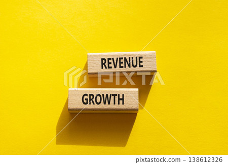 Revenue growth symbol. Concept word Revenue growth on wooden blocks. Beautiful yellow background. Business and Revenue growth concept. Copy space Revenue growth symbol. Concept word Revenue growth on wooden blocks. Beautiful yellow background. Business and Revenue growth concept. Copy space 138612326