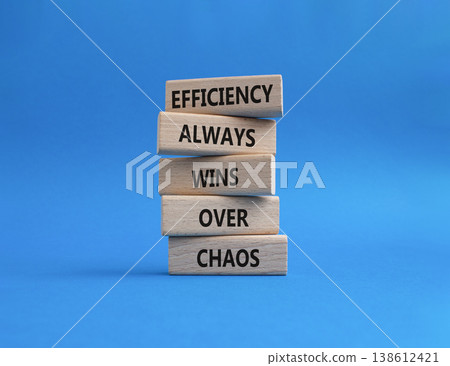 Efficiency symbol. Wooden blocks with words Efficiency Always Wins Over Chaos. Beautiful blue background. Businessman hand. Business and Efficiency concept. Copy space Efficiency symbol. Wooden blocks with words Efficiency Always Wins Over Chaos. Beautiful blue background. Businessman hand. Business and Efficiency concept. Copy space 138612421