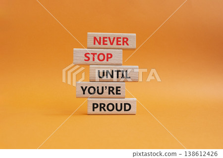 Never Stop symbol. Wooden blocks with words Never Stop Until You are Proud. Beautiful orange background. Business and Never Stop concept. Copy space Never Stop symbol. Wooden blocks with words Never Stop Until You are Proud. Beautiful orange background. Business and Never Stop concept. Copy space 138612426