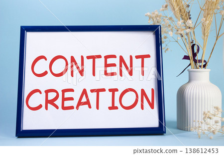Content creation symbol. Concept words Content creation on beautiful wooden picture frame. Beautiful light blue background with flower vase. Business and Content creation concept. Copy space. Content creation symbol. Concept words Content creation on beautiful wooden picture frame. Beautiful light blue background with flower vase. Business and Content creation concept. Copy space. 138612453