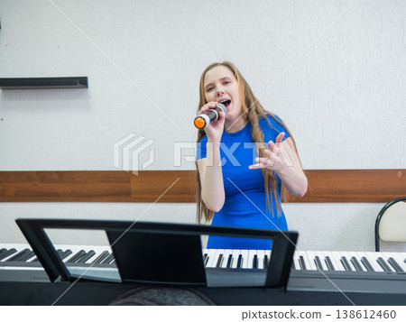 Caucasian woman singing into microphone.  138612460