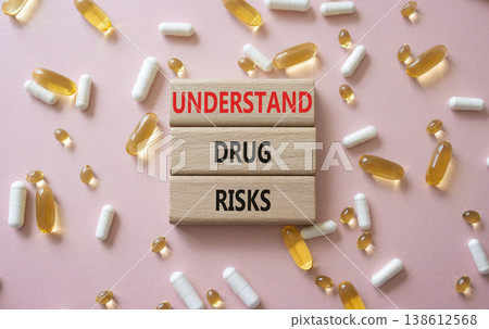 UNDERSTAND DRUG RISKS symbol. Concept words UNDERSTAND DRUG RISKS on wooden blocks. Beautiful pink background with pills. Healthcare and UNDERSTAND DRUG RISKS concept. Copy space. UNDERSTAND DRUG RISKS symbol. Concept words UNDERSTAND DRUG RISKS on wooden blocks. Beautiful pink background with pills. Healthcare and UNDERSTAND DRUG RISKS concept. Copy space. 138612568