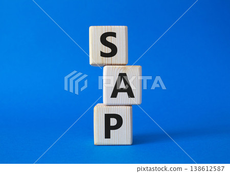 SAP - Systems Applications Products. Wooden cubes with word SAP. Beautiful blue background. Business and System Application Product concept. Copy space. 138612587