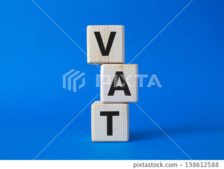 VAT - Value Added Tax symbol. Wooden cubes with word VAT. Beautiful blue background. Business and Value Added Tax concept. Copy space. VAT - Value Added Tax symbol. Wooden cubes with word VAT. Beautiful blue background. Business and Value Added Tax concept. Copy space. 138612588