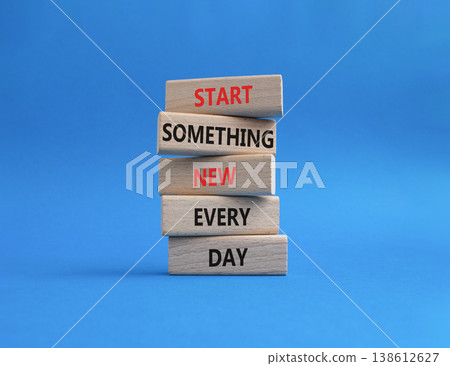 New symbol. Wooden blocks with words Start Something New Every Day. Beautiful blue background. Business and New concept. Copy space 138612627