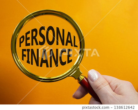 Personal Finance symbol. Magnifying Glass with words Personal Finance. Businessman hand. Beautiful orange background. Business and Personal Finance concept. Copy space. Personal Finance symbol. Magnifying Glass with words Personal Finance. Businessman hand. Beautiful orange background. Business and Personal Finance concept. Copy space. 138612642