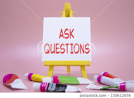 Ask Questions symbol. Wooden blocks with words Ask Questions. Beautiful pink background with paints and easel. Business and Ask Questions concept. Copy space. Ask Questions symbol. Wooden blocks with words Ask Questions. Beautiful pink background with paints and easel. Business and Ask Questions concept. Copy space. 138612656