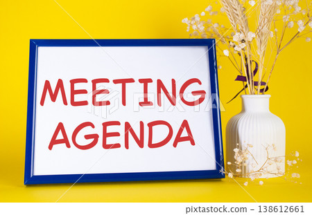 Meeting agenda symbol. Concept words Meeting agenda on beautiful wooden picture frame. Beautiful yellow background with flower vase. Business and Meeting agenda concept. Copy space. 138612661