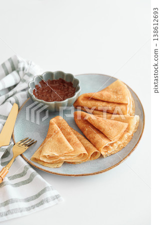 Crepes with chocolate cream and coffee on white wooden table 138612693