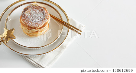 Stack of Golden Pancakes Dusted with Powdered Sugar with Coffee on White Table Stack of Golden Pancakes Dusted with Powdered Sugar with Coffee on White Table 138612699