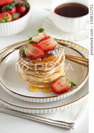 Stack of Golden Pancakes with Strawberry and Coffee on White Tablecakes with Strawberries and Coffee on White Background Stack of Golden Pancakes with Strawberry and Coffee on White Tablecakes with Strawberries and Coffee on White Background 138612701