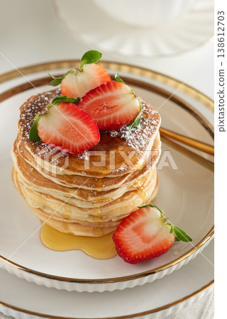 Stack of Golden Pancakes with Strawberry and Coffee on White Tablecakes with Strawberries and Coffee on White Background Stack of Golden Pancakes with Strawberry and Coffee on White Tablecakes with Strawberries and Coffee on White Background 138612703
