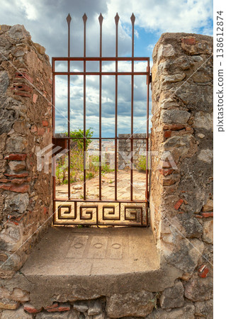 Rusty iron gate in ancient stone wall in Girona, Spain Rusty iron gate in ancient stone wall in Girona, Spain 138612874