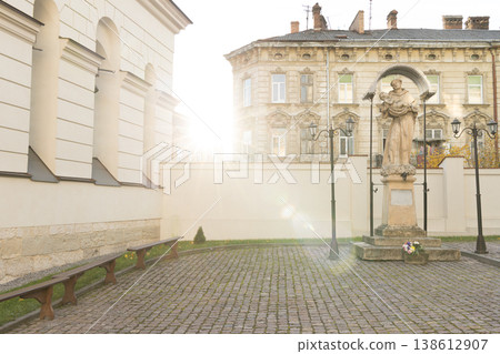 renaissance architecture historical European temple serene courtyard with a statue and benches in front of a historic building renaissance architecture historical European temple serene courtyard with a statue and benches in front of a historic building 138612907