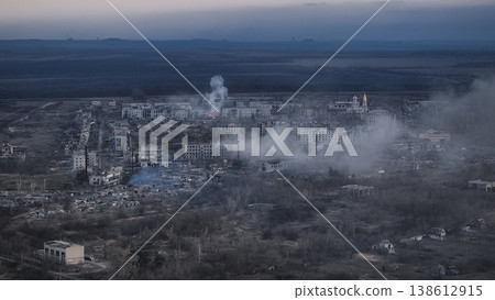 Aerial view of a city devastated by war, showing destroyed buildings and smoke plumes in Middle East region Iranian city Aerial view of a city devastated by war, showing destroyed buildings and smoke plumes in Middle East region Iranian city 138612915