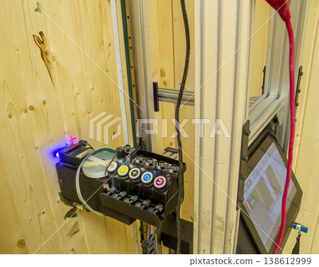 The device in the image is a vertical wall printer, a specialized inkjet printer designed to print directly onto vertical surfaces like walls 138612999