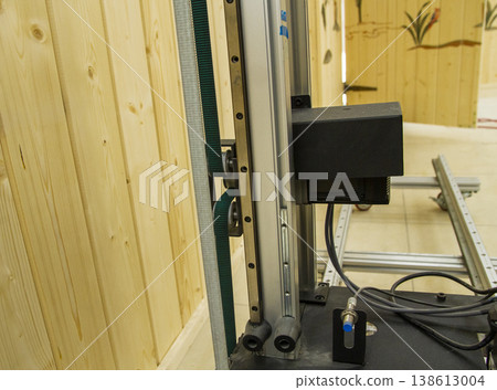 The device in the image is a vertical wall printer, a specialized inkjet printer designed to print directly onto vertical surfaces like walls 138613004