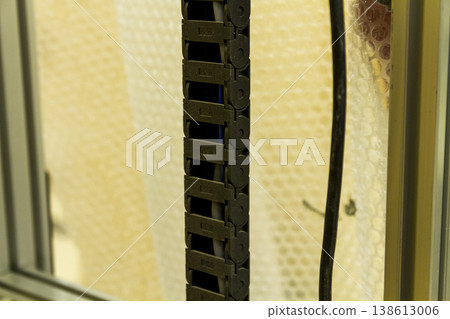 The device in the image is a vertical wall printer, a specialized inkjet printer designed to print directly onto vertical surfaces like walls The device in the image is a vertical wall printer, a specialized inkjet printer designed to print directly onto vertical surfaces like walls 138613006