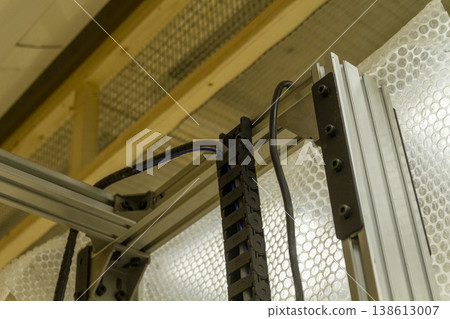 The device in the image is a vertical wall printer, a specialized inkjet printer designed to print directly onto vertical surfaces like walls The device in the image is a vertical wall printer, a specialized inkjet printer designed to print directly onto vertical surfaces like walls 138613007