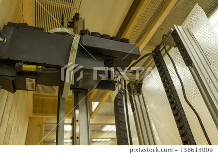 The device in the image is a vertical wall printer, a specialized inkjet printer designed to print directly onto vertical surfaces like walls The device in the image is a vertical wall printer, a specialized inkjet printer designed to print directly onto vertical surfaces like walls 138613009