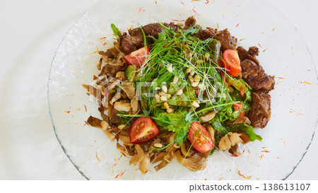 Warm beef salad with sauteed mushrooms, cherry tomatoes, and fresh microgreens Warm beef salad with sauteed mushrooms, cherry tomatoes, and fresh microgreens 138613107