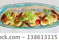 A multi-sensory gourmet appetizer featuring seared scallops with melted cheese 138613115